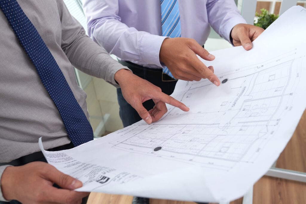 Engineers checking building codes according to footing types