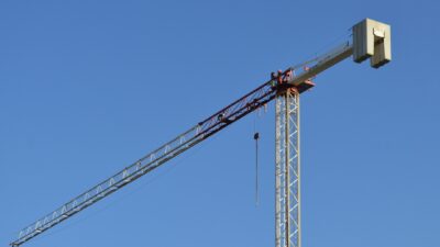 Crane at construction site lifting precast concrete panel