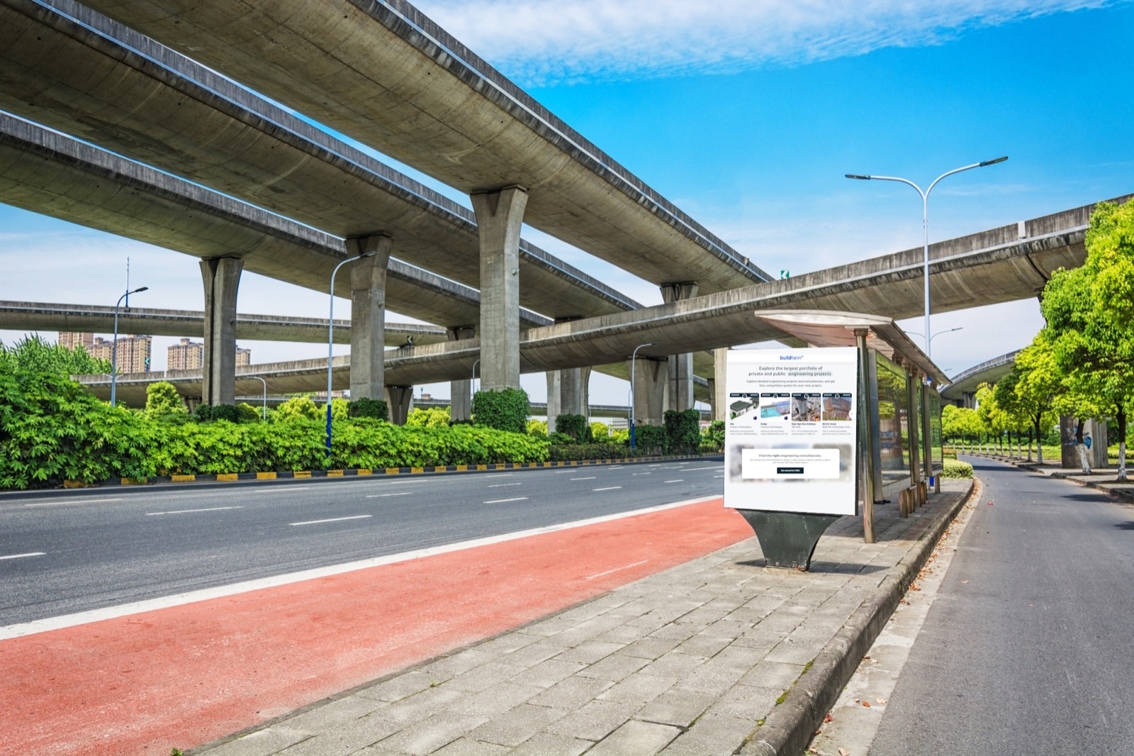 Two levels of elevated roadway carried on slender precast concrete piers and crossbeams, photographed from the empty carriageway beneath them